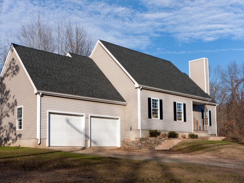 Modern custom built residential home newly constructed with a 2 car garage in a residential neighborhood.